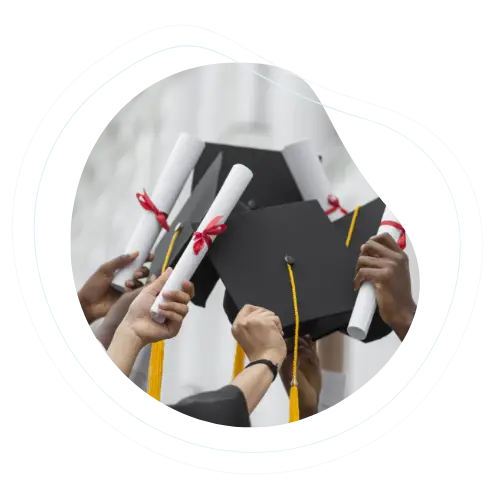 Education graduates raising their caps and diplomas in celebration.