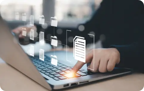 File transfer person using a laptop with digital icons of files and folders floating above the keyboard, representing data sharing.