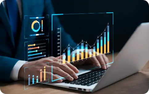Reporting business professional using a laptop with holographic bar and pie charts displaying data analytics and performance metrics.