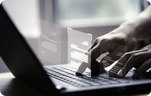 VFAX person typing on a laptop with digital fax documents appearing as holograms above the keyboard, representing virtual faxing.